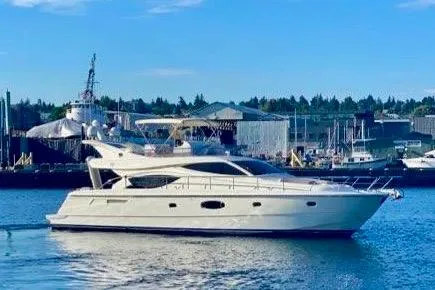 Slide: The Image of 2006 Ferretti Yachts 550 cruising in a harbor with industrial backdrop. - 28