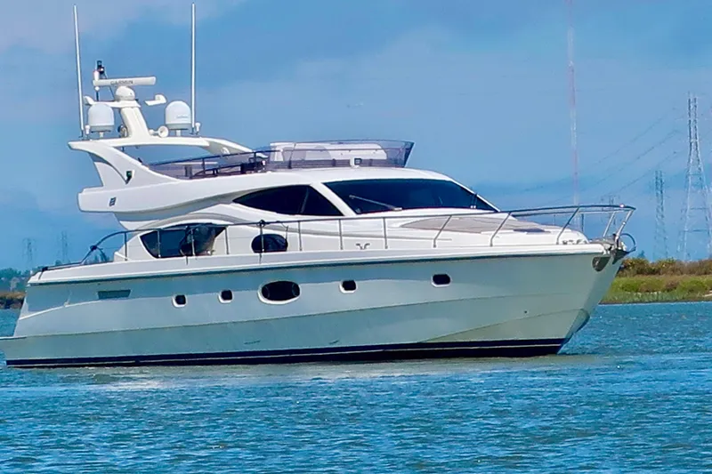 Slide: The Image of 2006 Ferretti Yachts 550 cruising on calm waters under a clear blue sky. - 3