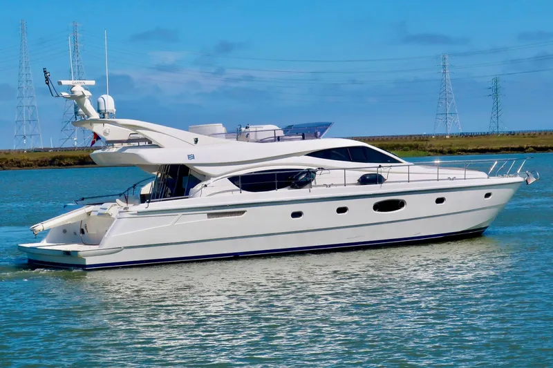 Slide: The Image of 2006 Ferretti Yachts 550 cruising on a calm blue waterway. - 4