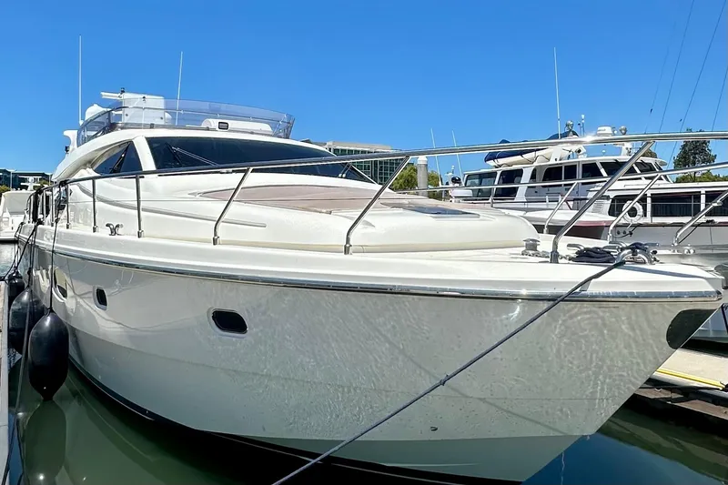 Slide: The Image of 2006 Ferretti Yachts 550 docked in marina, showcasing sleek design and luxury features. - 7