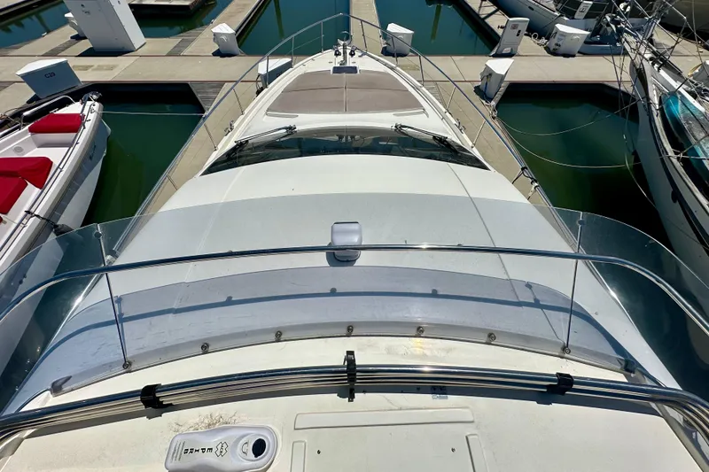 Slide: The Image of 2006 Ferretti Yachts 550 docked at marina, top view of deck and surroundings. - 8