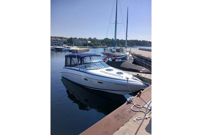The Image of 1998 Cobalt 293 boat docked at a marina on a sunny day. - 0
