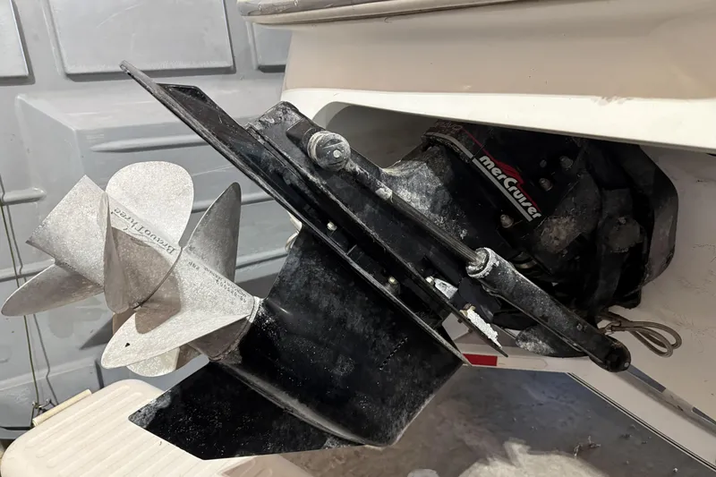 Slide: The Image of 1998 Cobalt 293 boat with MerCruiser outdrive and propeller in a garage setting. - 10