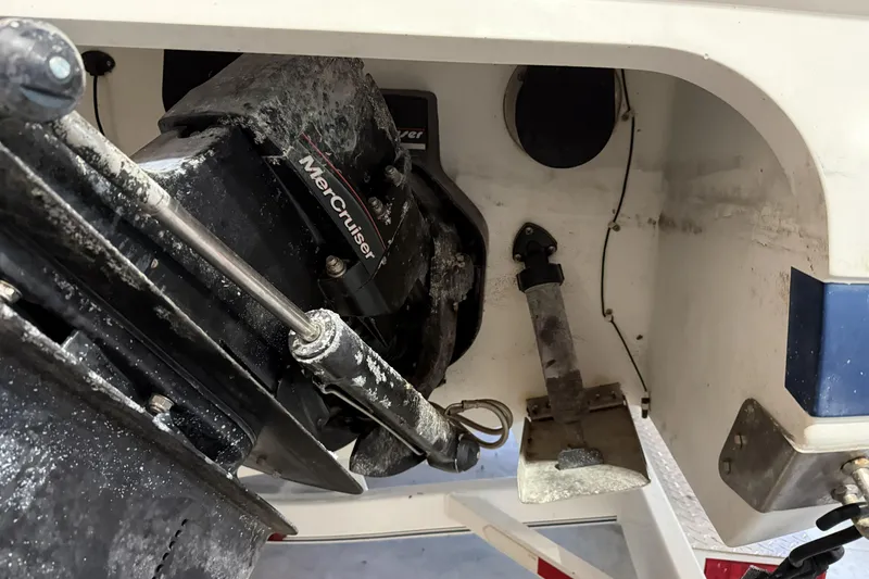 Slide: The Image of 1998 Cobalt 293 boat with MerCruiser engine, showing stern drive and propeller area. - 11