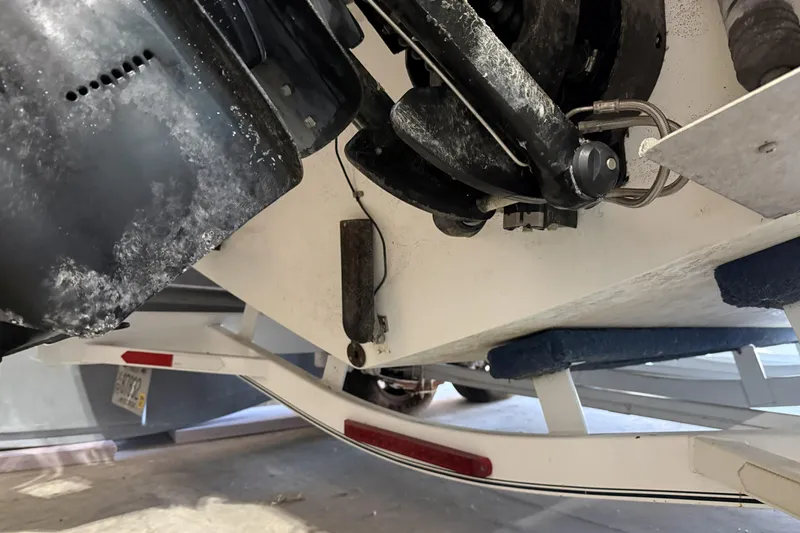 Slide: The Image of Close-up of a 1998 Cobalt 293 boat's engine and trailer components. - 12