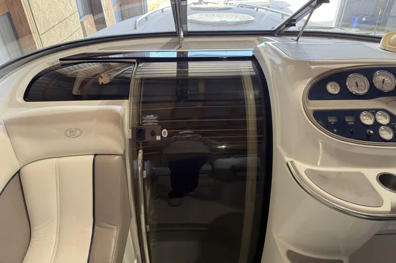 Slide: The Image of Interior view of a 1998 Cobalt 293 boat cockpit with gauges and seating. - 16