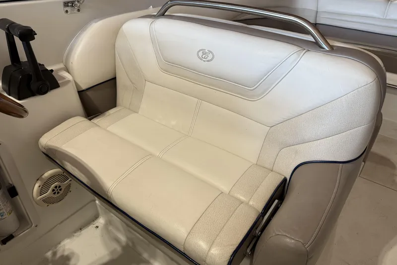 Slide: The Image of 1998 Cobalt 293 boat interior with white leather seating and control panel. - 17