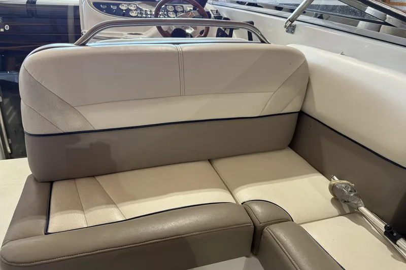 Slide: The Image of 1998 Cobalt 293 boat interior with beige and brown seating, steering wheel visible. - 20