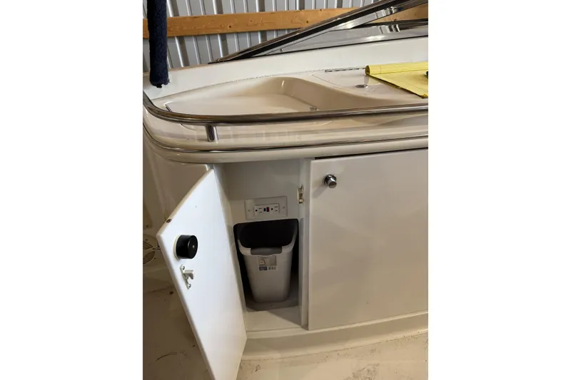 Slide: The Image of 1998 Cobalt 293 boat interior with open cabinet and sink. - 21