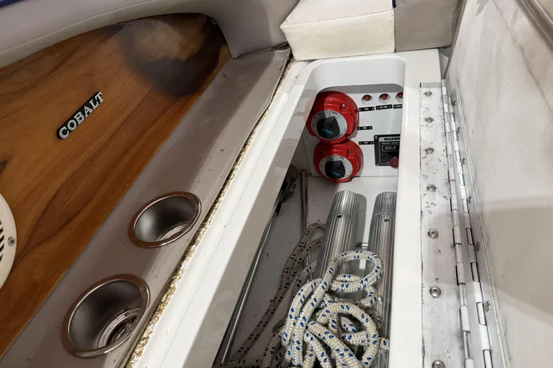 Slide: The Image of Interior of a 1998 Cobalt 293 boat showing storage compartment with ropes and control panel. - 28