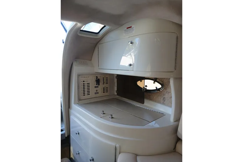 Slide: The Image of Interior of 1998 Cobalt 293 boat featuring control panel and storage compartments. - 30