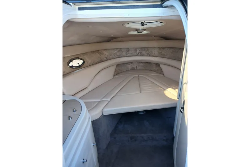 Slide: The Image of Interior cabin of a 1998 Cobalt 293 boat with beige seating and porthole. - 31