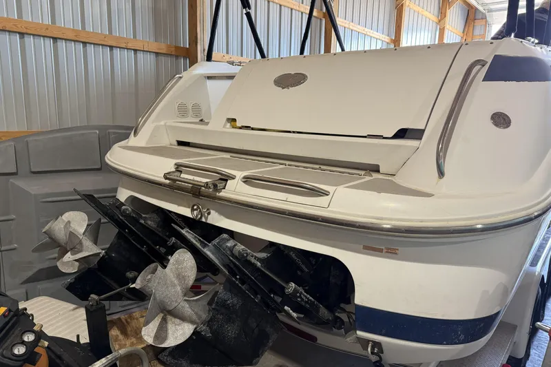Slide: The Image of 1998 Cobalt 293 boat in storage, showing dual propellers and stern details. - 7