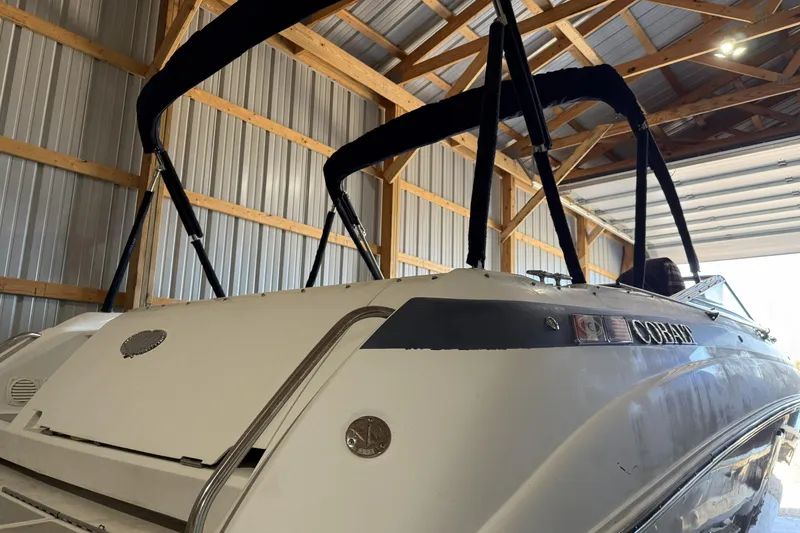 Slide: The Image of 1998 Cobalt 293 boat stored in a wooden garage, featuring a sleek design. - 8