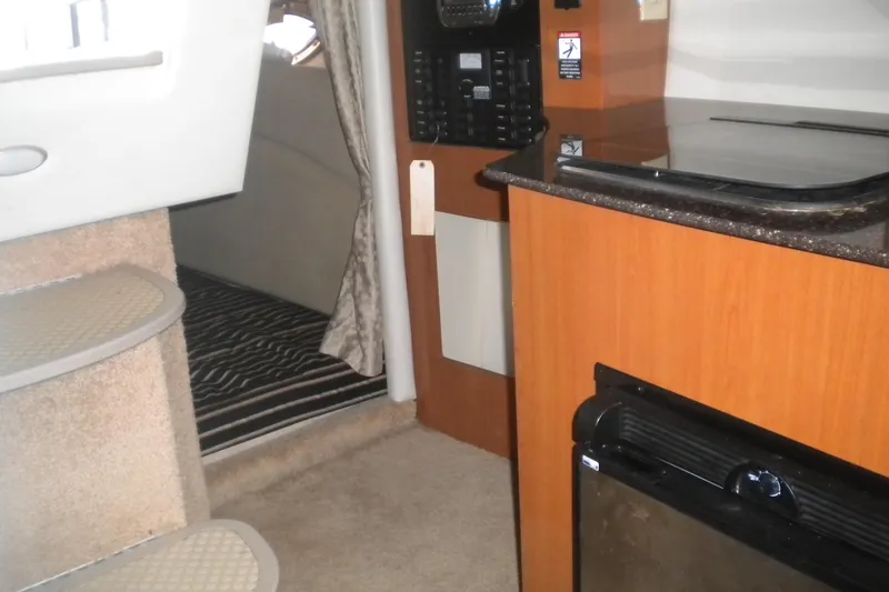Slide: The Image of Interior of 2009 Maxum 2700 SE boat with kitchenette and cabin entrance. - 15