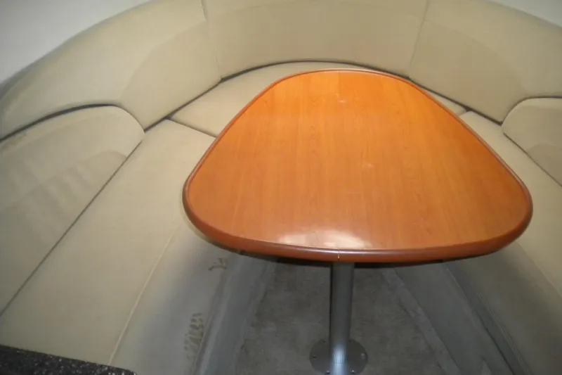 Slide: The Image of Cozy seating area with wooden table in 2009 Maxum 2700 SE boat. - 16