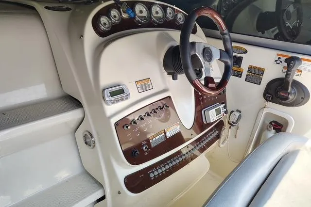 Slide: The Image of 2009 Maxum 2700 SE boat dashboard with steering wheel and control panel. - 5