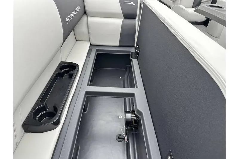 Slide: The Image of 2026 Bennington 20 SSR Quad Bench Tritoon interior storage and seating detail. - 19