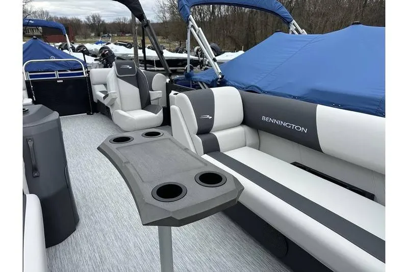 Slide: The Image of 2026 Bennington 20 SSR Quad Bench Tritoon interior with Yamaha 115 HP, featuring seating and table. - 20