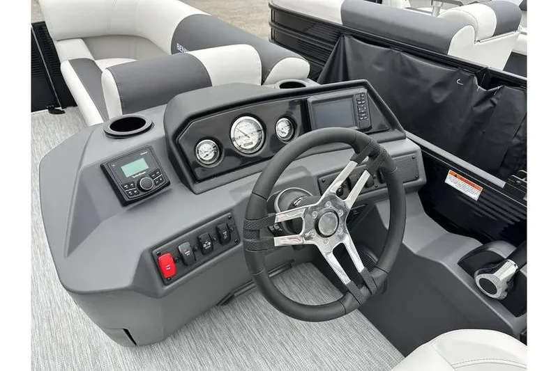Slide: The Image of 2026 Bennington 20 SSR Quad Bench Tritoon dashboard with steering wheel and controls. - 22