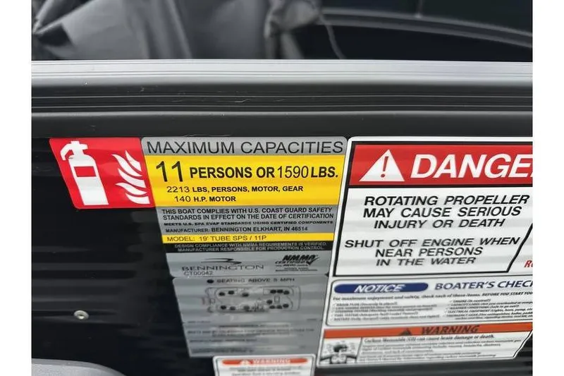 Slide: The Image of Capacity and safety warning labels on a 2026 Bennington 20 SSR Quad Bench Tritoon. - 23