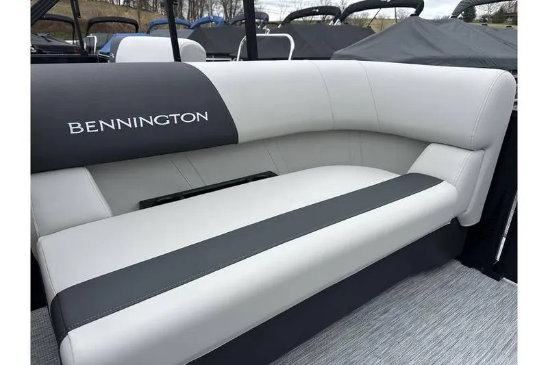 Slide: The Image of 2026 Bennington 20 SSR Quad Bench Tritoon interior seating with logo detail. - 26