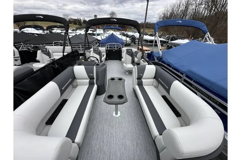 Slide: The Image of 2026 Bennington 20 SSR Quad Bench Tritoon with Yamaha 115 HP, spacious seating, docked outdoors. - 31