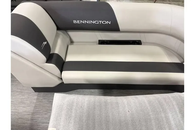 Slide: The Image of 2026 Bennington 20 SSR Quad Bench Tritoon interior seating, featuring sleek gray and white upholstery. - 4