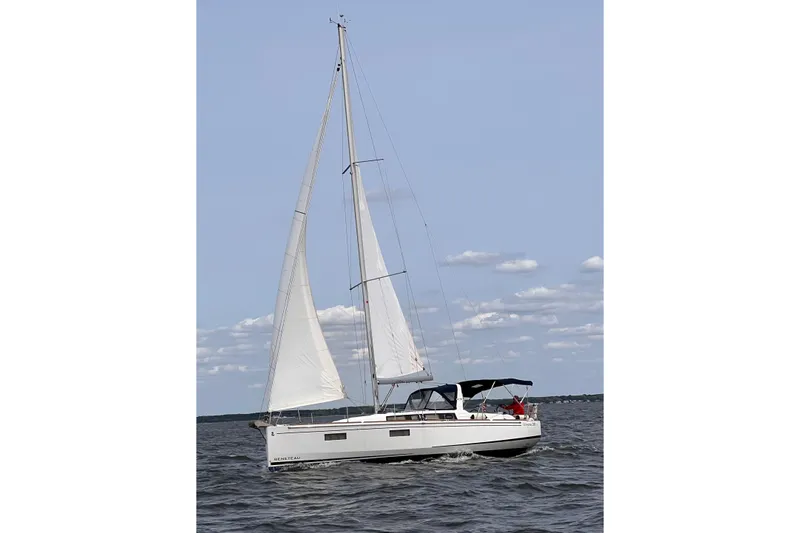 The Image of 2021 Beneteau Oceanis 38.1 sailing on open water under clear skies. - 0