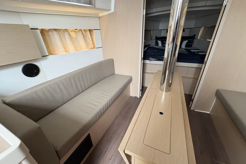 Slide: The Image of Interior of 2021 Beneteau Oceanis 38.1 yacht, featuring modern seating and sleek design. - 14