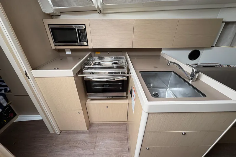 Slide: The Image of Modern kitchen in 2021 Beneteau Oceanis 38.1 yacht with stove, sink, and microwave. - 15