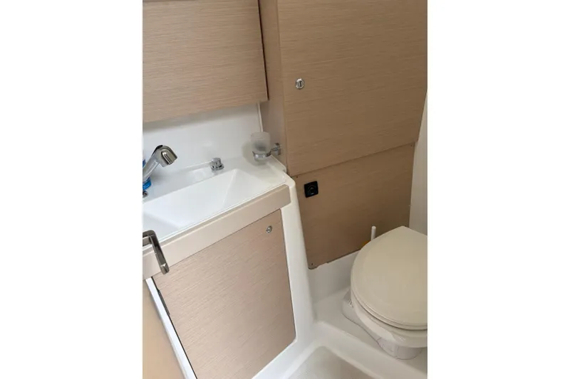 Slide: The Image of Bathroom interior of 2021 Beneteau Oceanis 38.1 yacht, featuring sink and toilet. - 18
