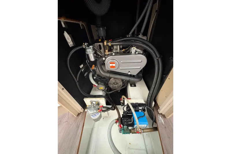 Slide: The Image of Engine compartment of 2021 Beneteau Oceanis 38.1 sailboat, showcasing mechanical components. - 23