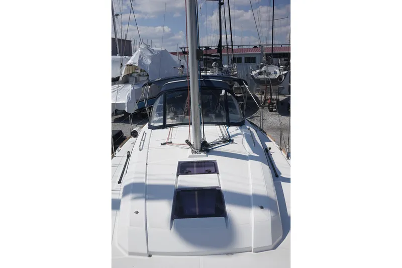 Slide: The Image of 2021 Beneteau Oceanis 38.1 sailboat docked, showcasing sleek deck design. - 26