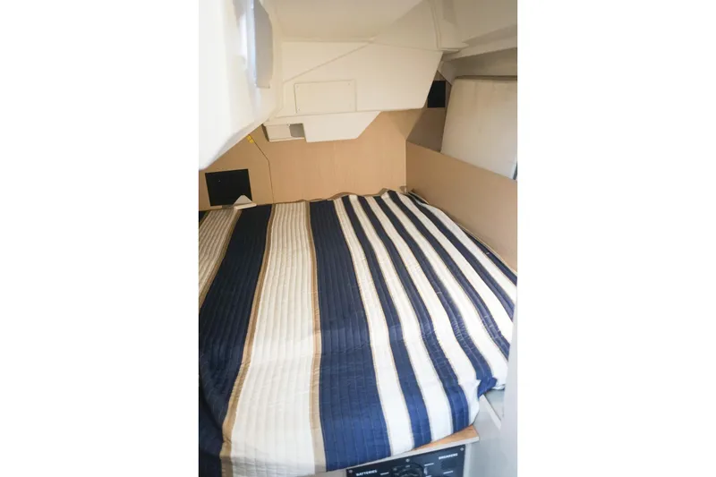 Slide: The Image of Interior cabin of 2021 Beneteau Oceanis 38.1 with striped bedding. - 29