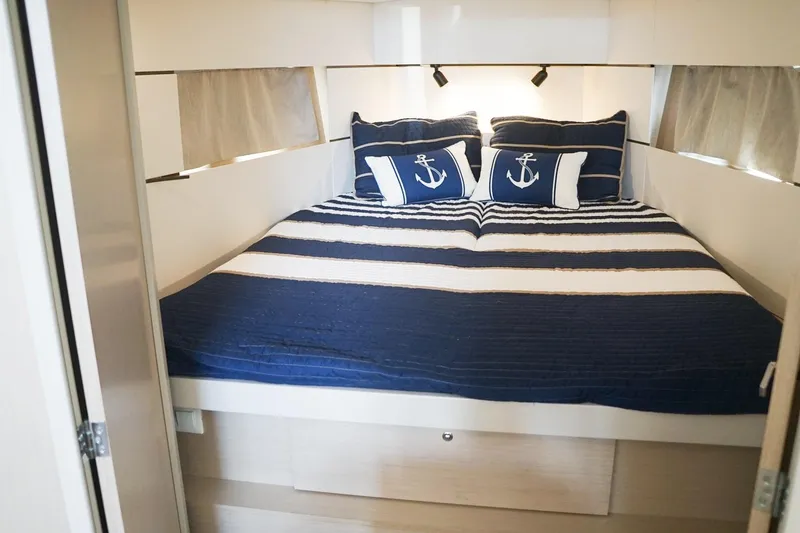 Slide: The Image of Cozy cabin bedroom in 2021 Beneteau Oceanis 38.1 yacht with nautical-themed bedding. - 30
