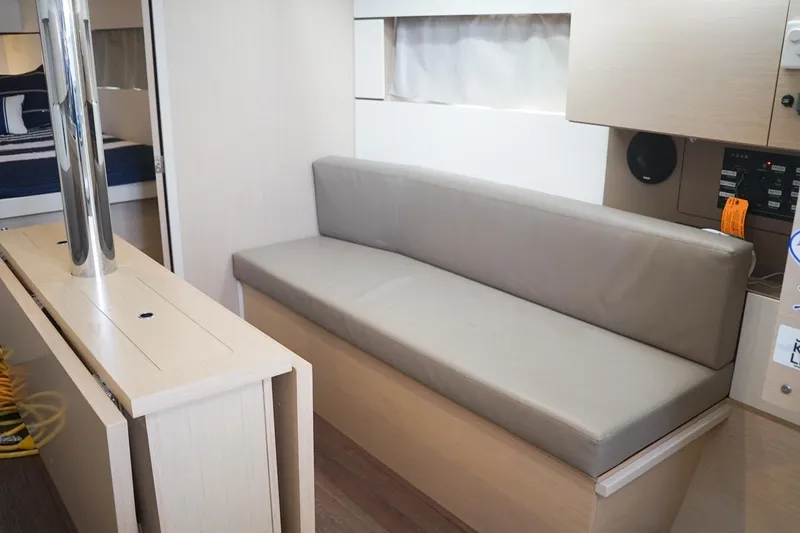 Slide: The Image of Interior of 2021 Beneteau Oceanis 38.1 yacht with modern seating and sleek design. - 32
