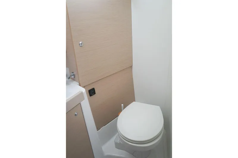 Slide: The Image of Bathroom interior of 2021 Beneteau Oceanis 38.1 yacht, featuring a compact toilet. - 33