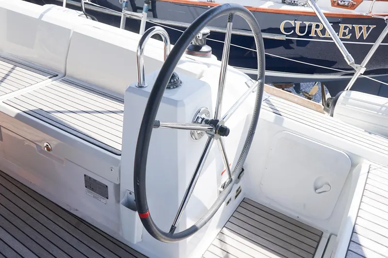 Slide: The Image of Steering wheel of a 2021 Beneteau Oceanis 38.1 sailboat, docked at marina. - 39
