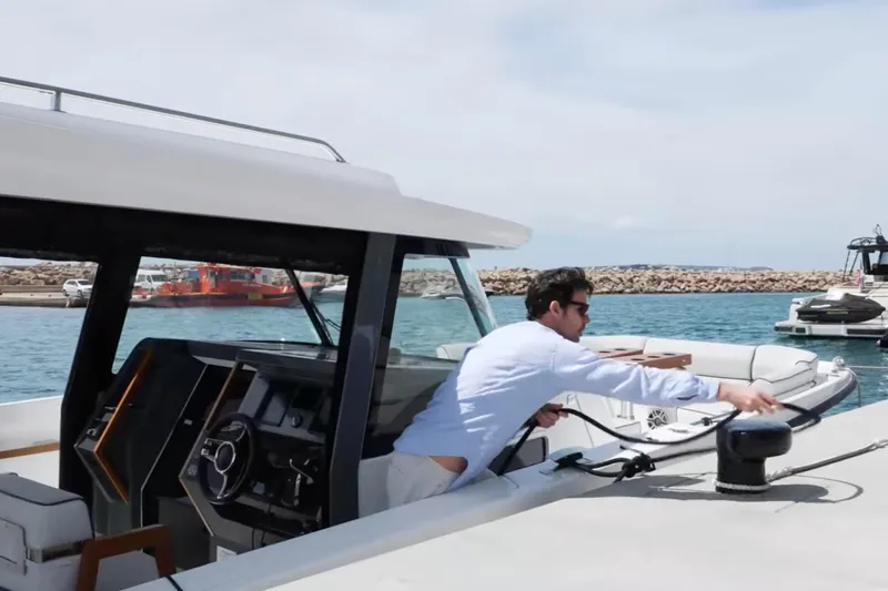 Slide: The Image of Man securing Aiata Wayfinder 38 Suntop boat at marina, 2026 model. - 17