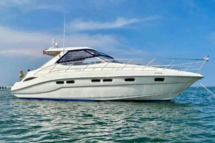 The Image of 2001 Sealine S41 Sports Cruiser on calm water under a clear blue sky. - 0