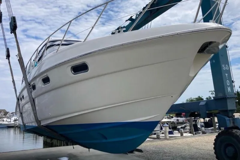 Slide: The Image of 2001 Sealine S41 Sports Cruiser being lifted at a marina. - 10