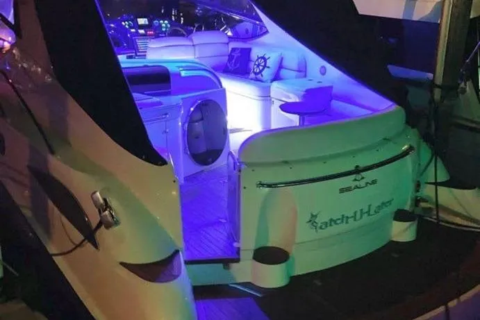 Slide: The Image of Sealine S41 Sports Cruiser 2001 with illuminated interior and luxurious seating at night. - 12