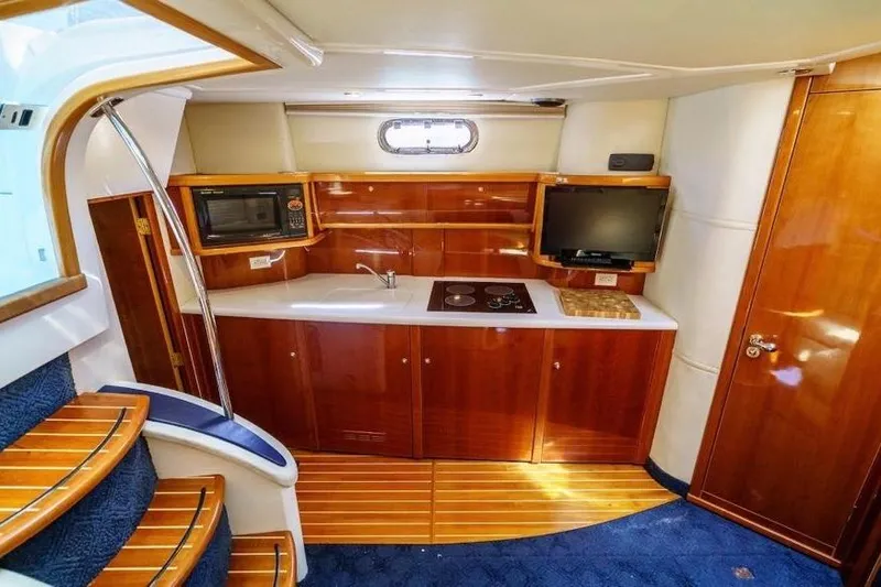 Slide: The Image of Luxurious 2001 Sealine S41 Sports Cruiser interior with modern kitchen amenities. - 16