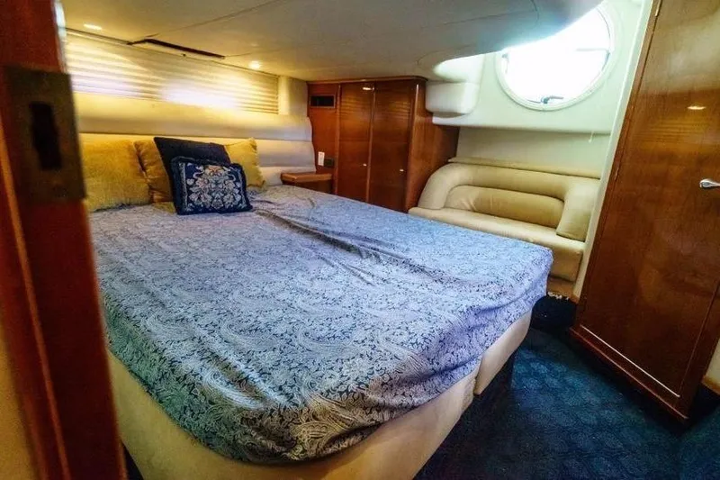 Slide: The Image of Luxurious cabin interior of 2001 Sealine S41 Sports Cruiser with elegant bedding and wood finishes. - 17