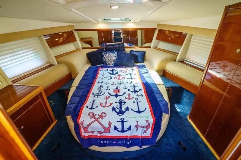Slide: The Image of Luxurious cabin interior of 2001 Sealine S41 Sports Cruiser with nautical-themed bedding. - 19