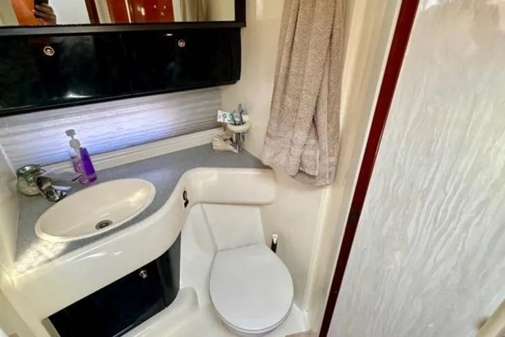 Slide: The Image of Bathroom interior of 2001 Sealine S41 Sports Cruiser with sink, toilet, and shower. - 21