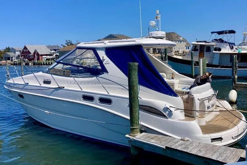 Slide: The Image of 2001 Sealine S41 Sports Cruiser docked at marina under clear blue sky. - 4