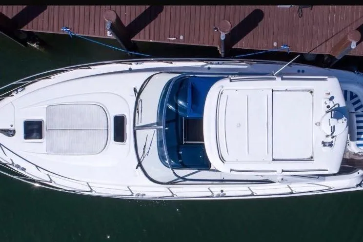 Slide: The Image of Top view of a 2001 Sealine S41 Sports Cruiser docked at a wooden pier. - 5
