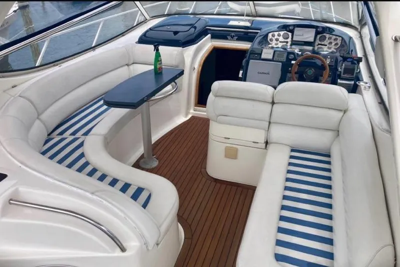 Slide: The Image of 2001 Sealine S41 Sports Cruiser interior with white seating and striped cushions. - 7